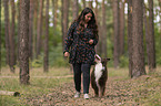 woman and Miniature Australian Shepherd